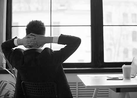 businessman staring out office window