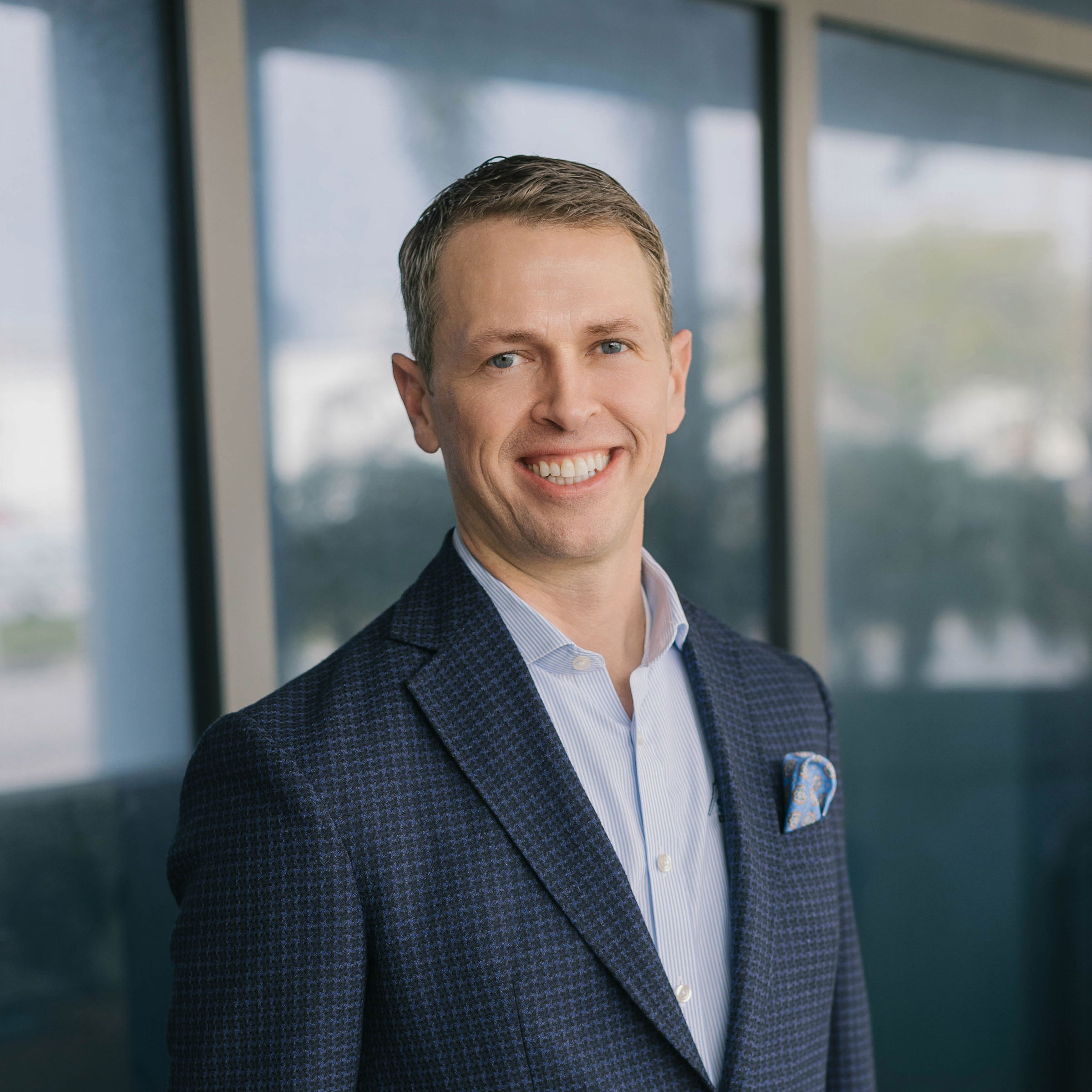 man in suit jacket smiling